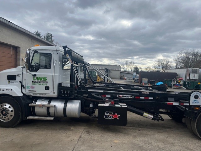 LWS Dumpsters truck delivering a construction roll-off near West Pikeland Township and Chester Springs, PA